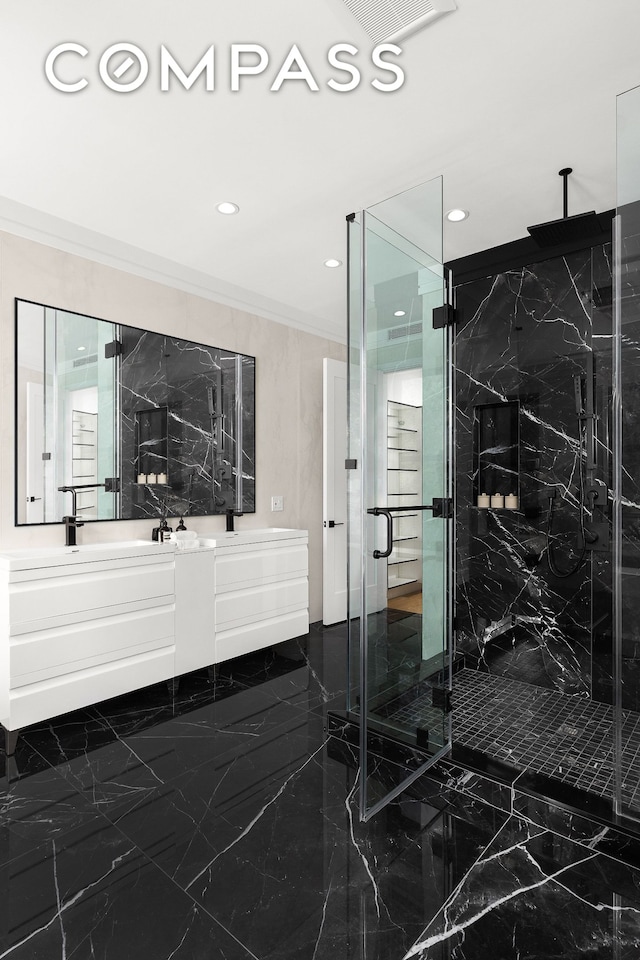 full bath with double vanity, marble finish floor, a marble finish shower, and ornamental molding