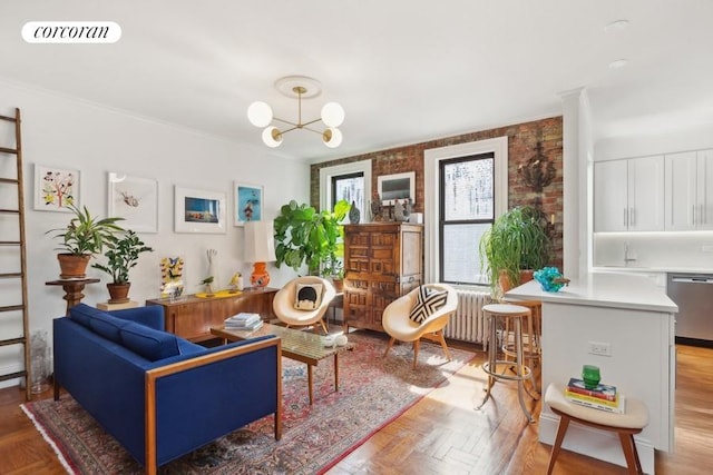 living area with visible vents, radiator, and an inviting chandelier