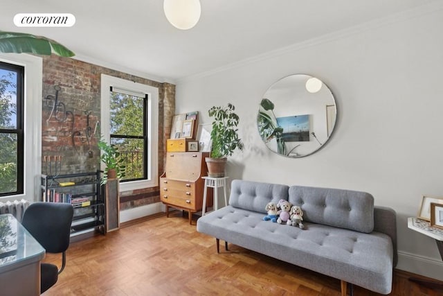 sitting room with crown molding, baseboards, and visible vents