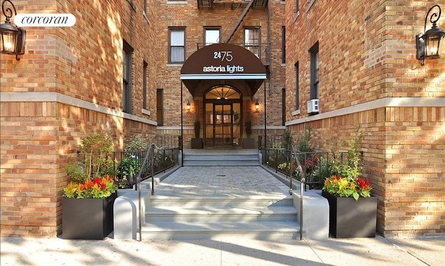 view of exterior entry with brick siding