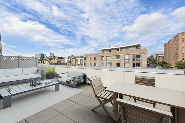 view of patio featuring outdoor dining area, an outdoor hangout area, and a city view