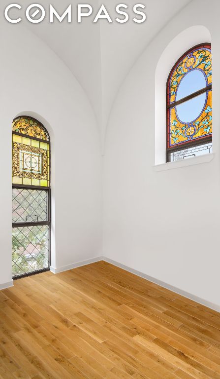 empty room with hardwood / wood-style flooring