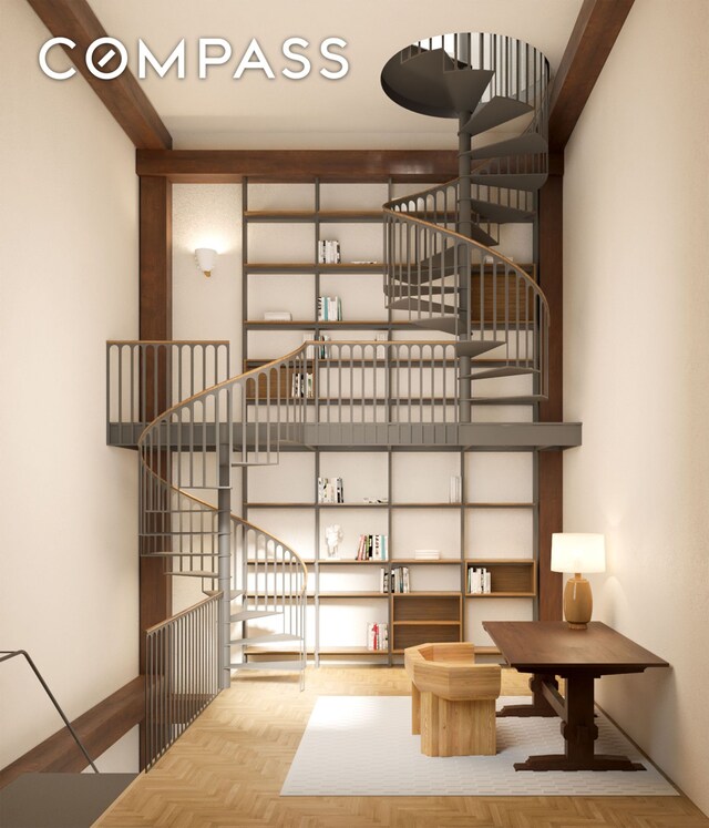 stairs featuring a towering ceiling and hardwood / wood-style floors