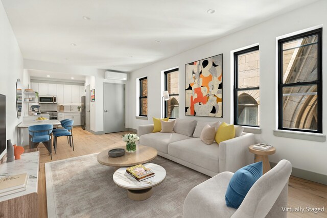 463 W 142nd St Phb, Phb, New York City, NY 10031 - living area with a wall mounted air conditioner, light wood finished floors, baseboards, and recessed lighting