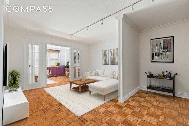 living room featuring light parquet flooring, track lighting, crown molding, and french doors