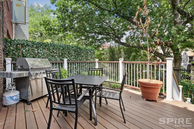 wooden terrace featuring a grill