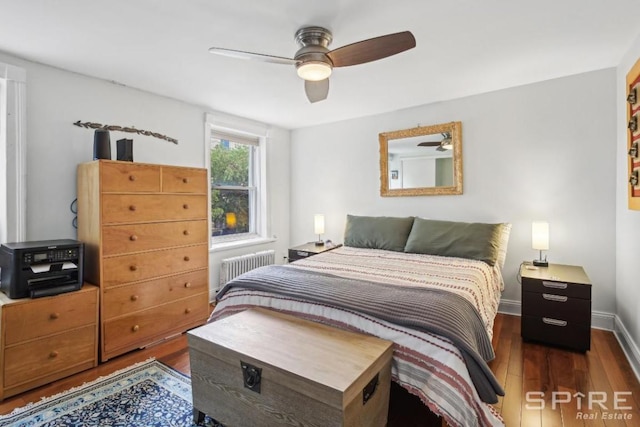 bedroom featuring dark hardwood / wood-style floors, radiator heating unit, and ceiling fan