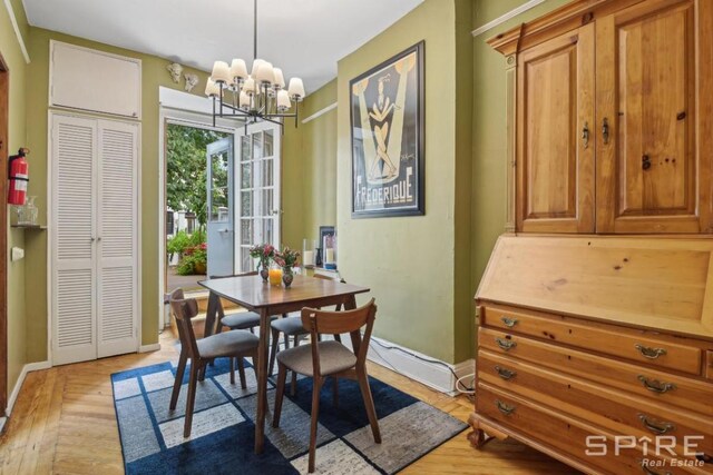 interior space featuring ceiling fan with notable chandelier, radiator heating unit, crown molding, and light hardwood / wood-style flooring