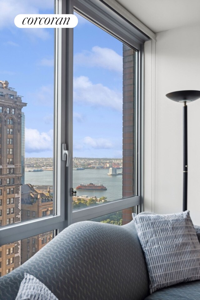 bedroom featuring a wall of windows and a water view