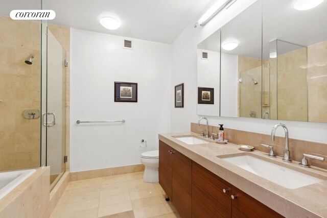 30 W St Unit 33B, New York City, NY 10004 - full bathroom featuring a shower stall, double vanity, tile patterned flooring, toilet, and a bath