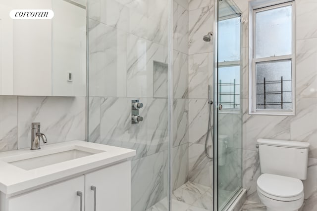 bathroom with a shower with door, decorative backsplash, toilet, and vanity