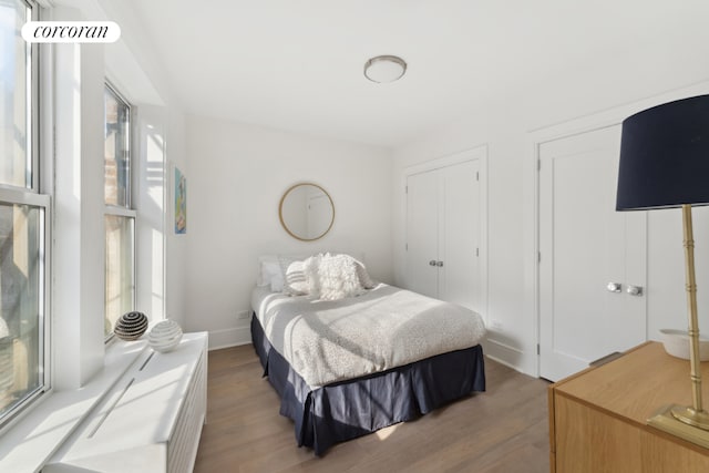 bedroom with hardwood / wood-style flooring