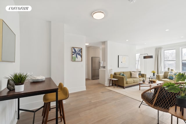 living room with light hardwood / wood-style flooring