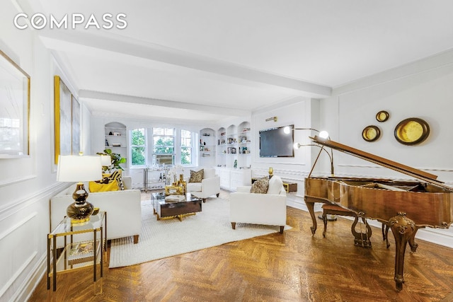 living room with parquet flooring, built in features, and beamed ceiling