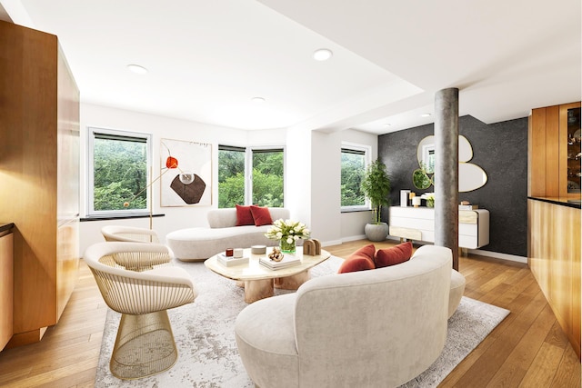 living area featuring light wood-style floors, an accent wall, baseboards, and recessed lighting