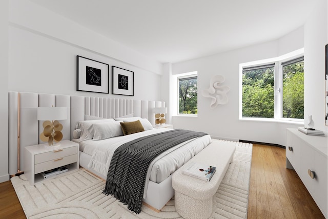 bedroom featuring baseboards and hardwood / wood-style flooring