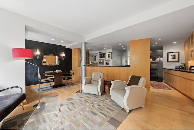 living area with light wood-style floors, recessed lighting, and ornate columns