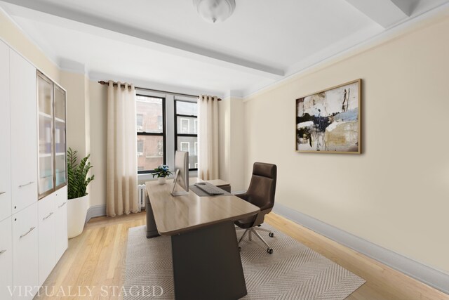 home office with light hardwood / wood-style flooring and beamed ceiling