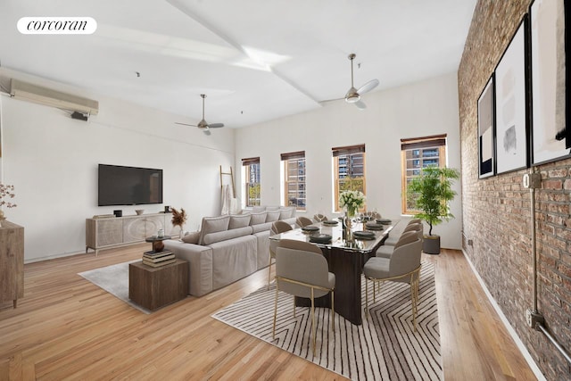 dining area featuring brick wall, a ceiling fan, visible vents, and light wood-style floors