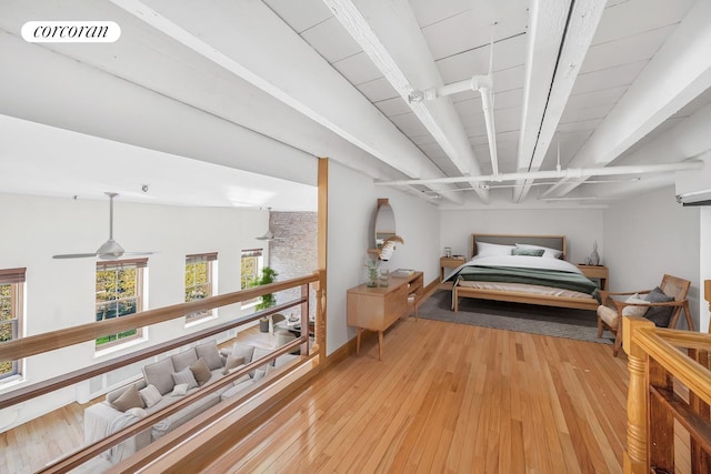 bedroom featuring light wood-type flooring, visible vents, and beamed ceiling