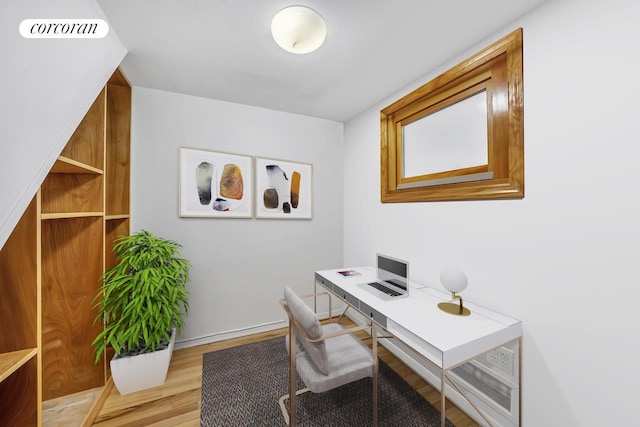 home office featuring baseboards, visible vents, and wood finished floors