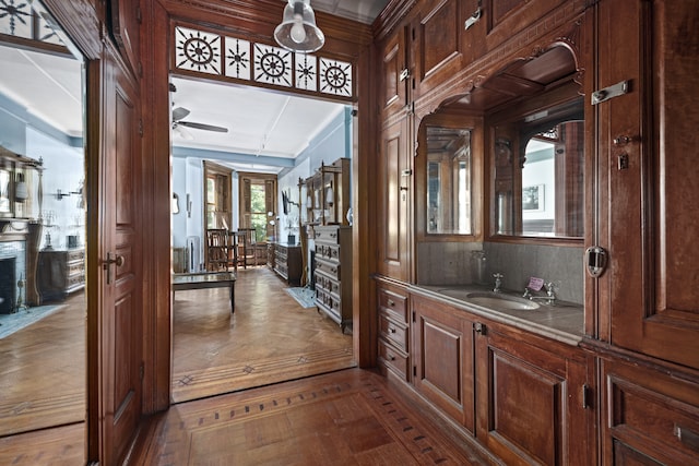 bathroom featuring vanity, ceiling fan, and a premium fireplace