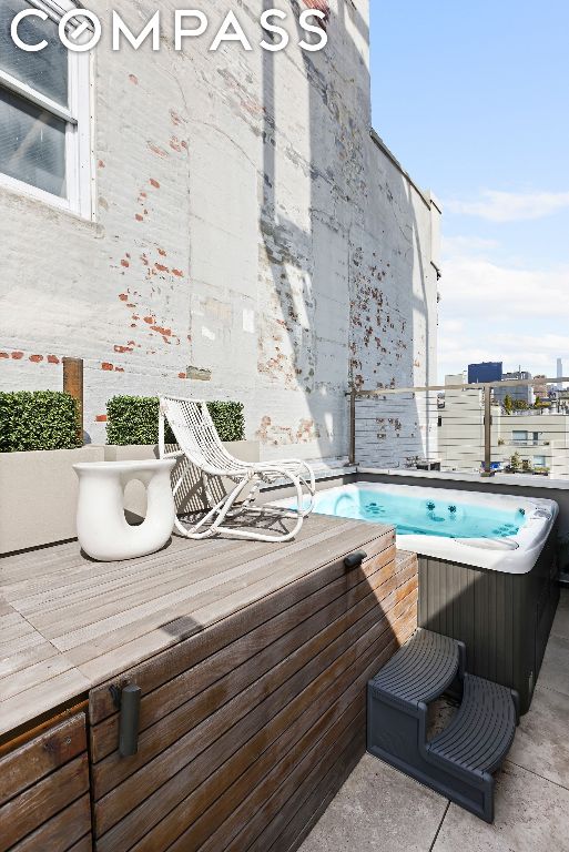 view of pool with a hot tub