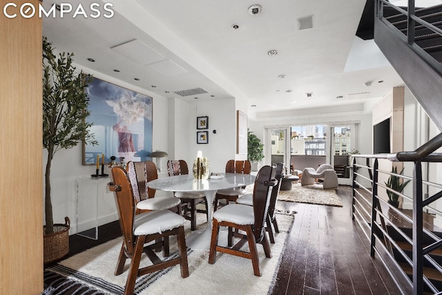 dining space with wood-type flooring