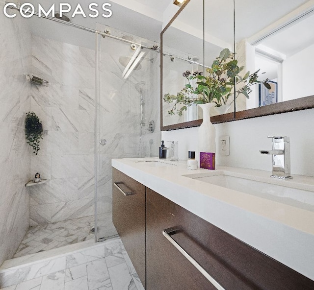 bathroom with vanity and a shower with door