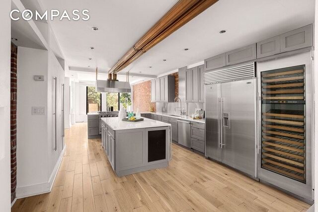 hall featuring light wood-type flooring and an inviting chandelier