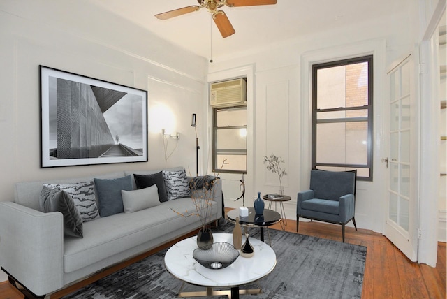 living room featuring an AC wall unit, ceiling fan, and hardwood / wood-style flooring