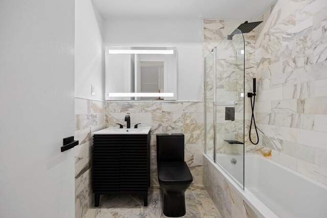 583 Putnam Ave Unit 4, New York City, NY 11221 - bathroom with tiled shower / bath combo, vanity, tile walls, and marble finish flooring