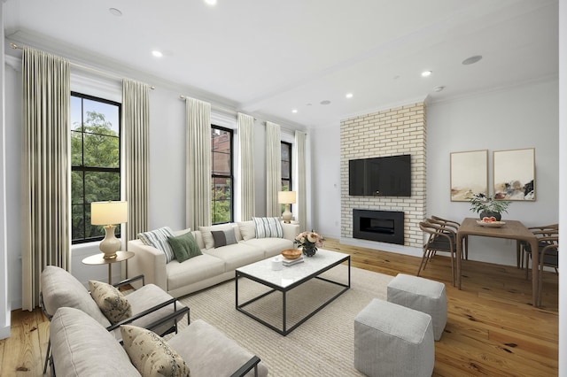 living room featuring recessed lighting, wood finished floors, a fireplace, and ornamental molding