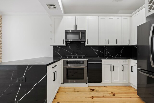 583 Putnam Ave Unit 4, New York City, NY 11221 - kitchen featuring appliances with stainless steel finishes, white cabinetry, decorative backsplash, light wood finished floors, and ornamental molding