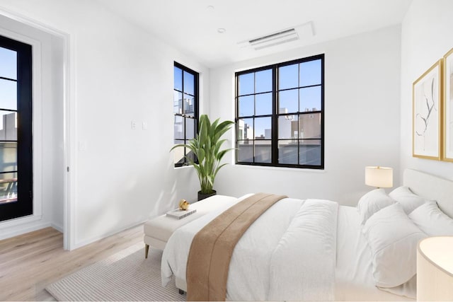 bedroom with light hardwood / wood-style floors