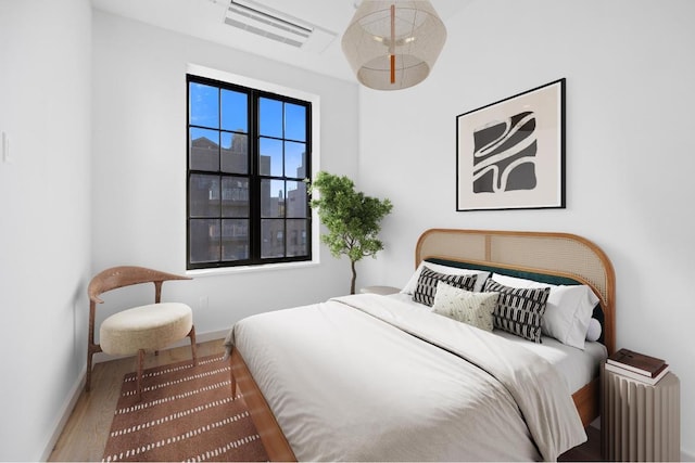 bedroom with hardwood / wood-style flooring