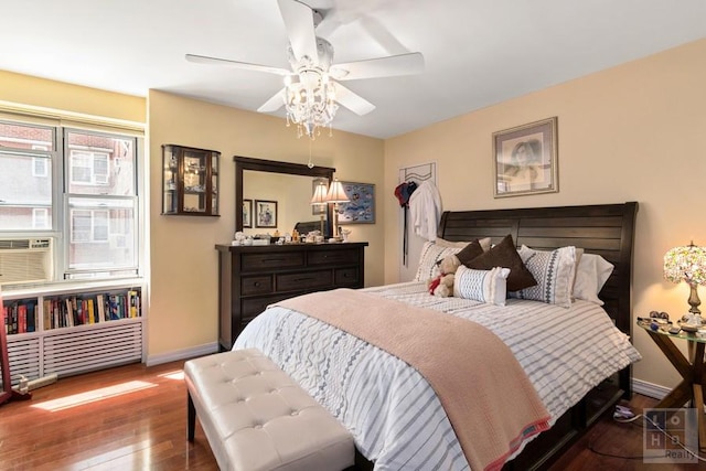 bedroom featuring baseboards, ceiling fan, and hardwood / wood-style flooring