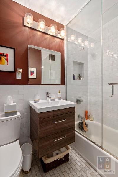 full bathroom featuring vanity, tile walls, toilet, and shower / bath combination with glass door