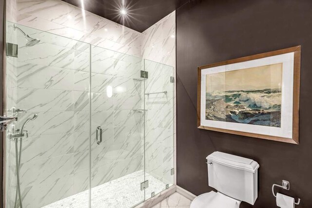 124 E 62nd St, New York City, NY 10065 - full bathroom with toilet, marble finish floors, a shower stall, and baseboards