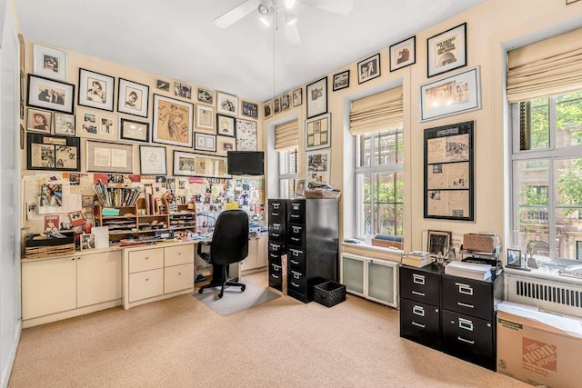 office with light carpet, a ceiling fan, and a healthy amount of sunlight