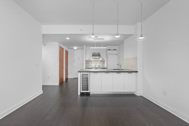 kitchen with paneled built in refrigerator, wine cooler, dark wood-style flooring, and white cabinetry