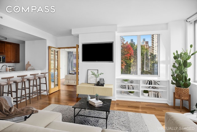 200 W End Ave Unit 5H, New York City, NY 10023 - living area with french doors and wood finished floors