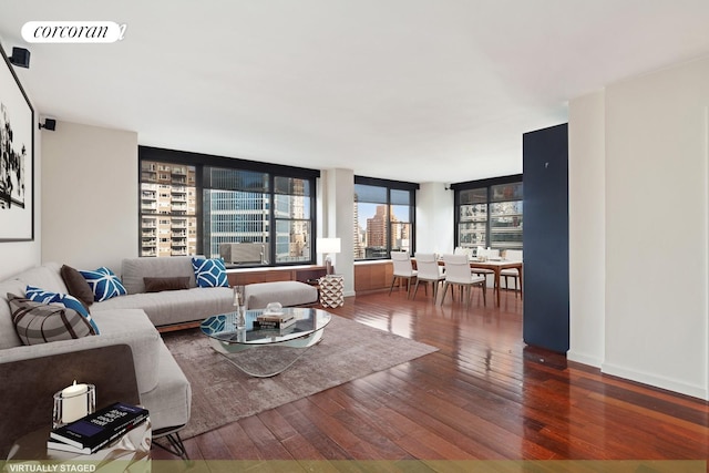 living area featuring visible vents, baseboards, and wood-type flooring