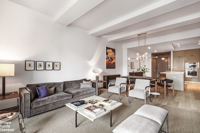 living room featuring an inviting chandelier and light hardwood / wood-style flooring