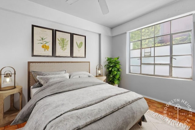 bedroom with a ceiling fan and baseboards