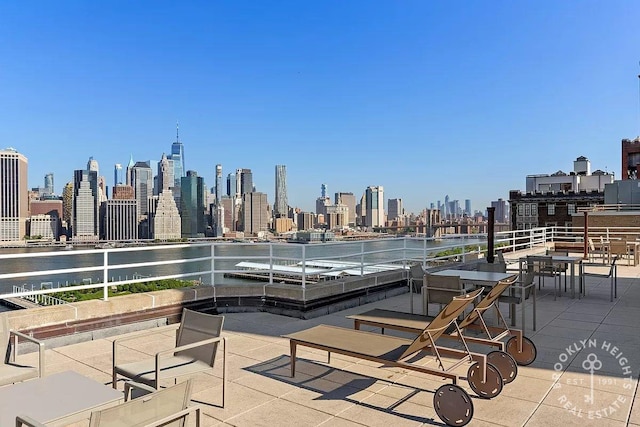 view of patio with a city view and a water view