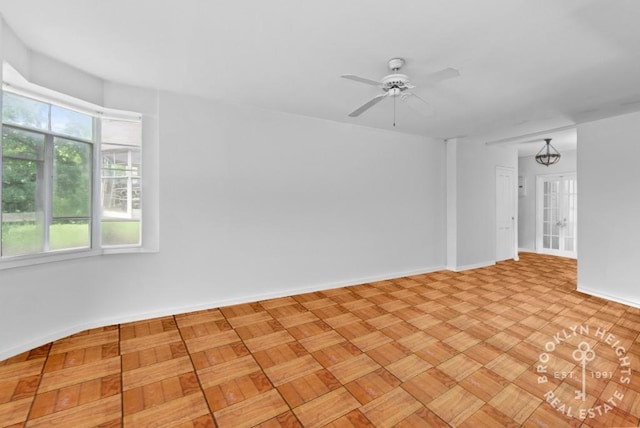 spare room featuring ceiling fan and light parquet floors