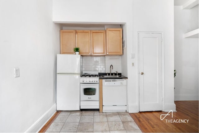 kitchen with sink, decorative backsplash, light tile patterned floors, light brown cabinets, and white appliances