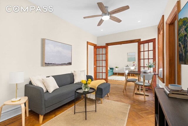 living room with ceiling fan, light parquet flooring, and radiator heating unit