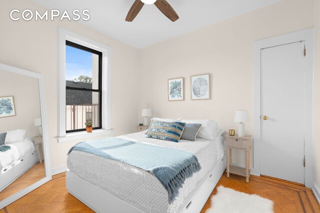 bedroom with ceiling fan and parquet floors